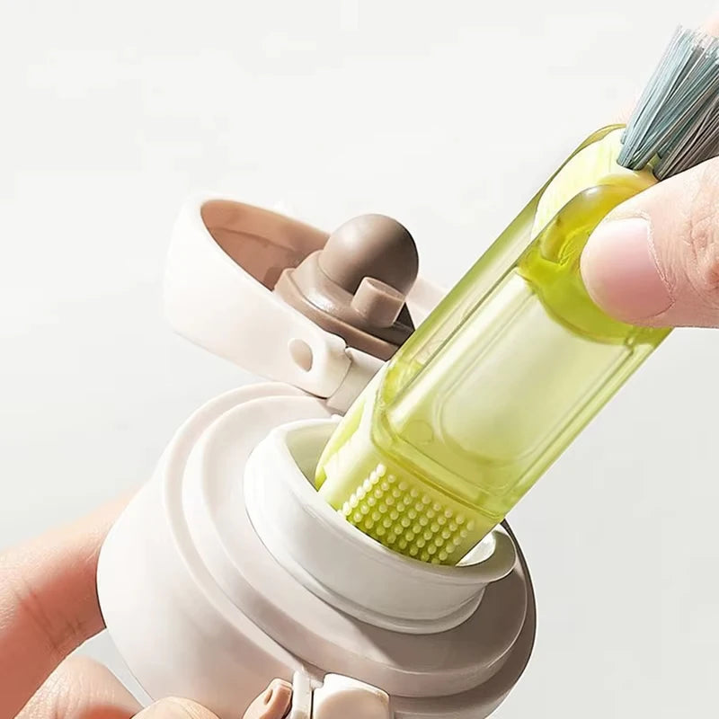 Bottle brush cleaning tool with a green brush head held by a hand against a white background