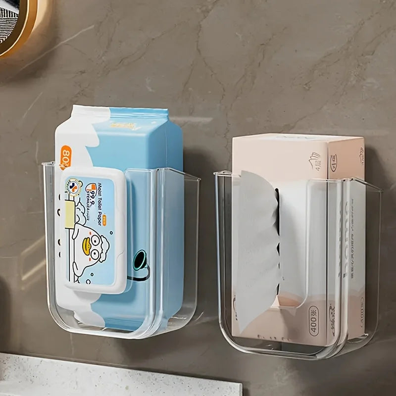 Two clear wall-mounted organizers holding packs of wipes on a marble surface.